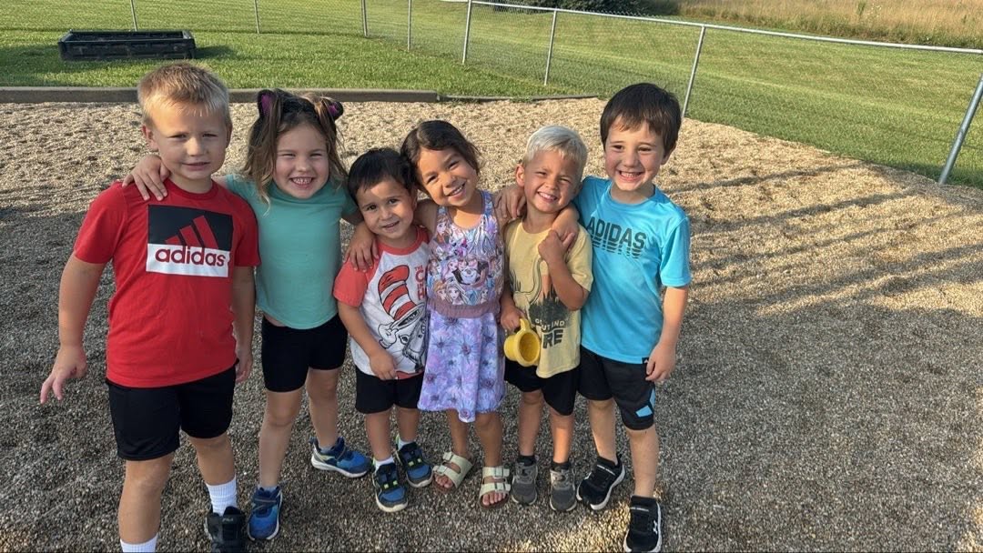 Children and caregivers sharing a joyful moment together at River of Life Daycare
