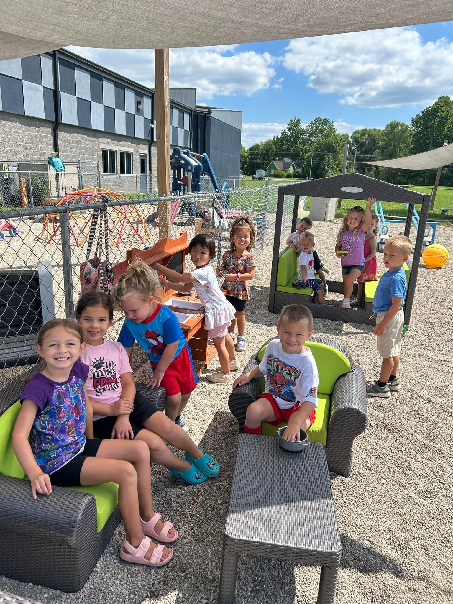 Children playing together in a bright, welcoming classroom at River of Life Daycare