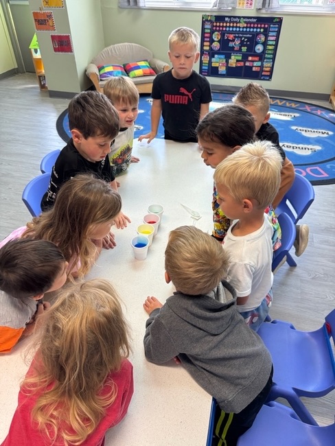 Preschoolers doing a group color activity