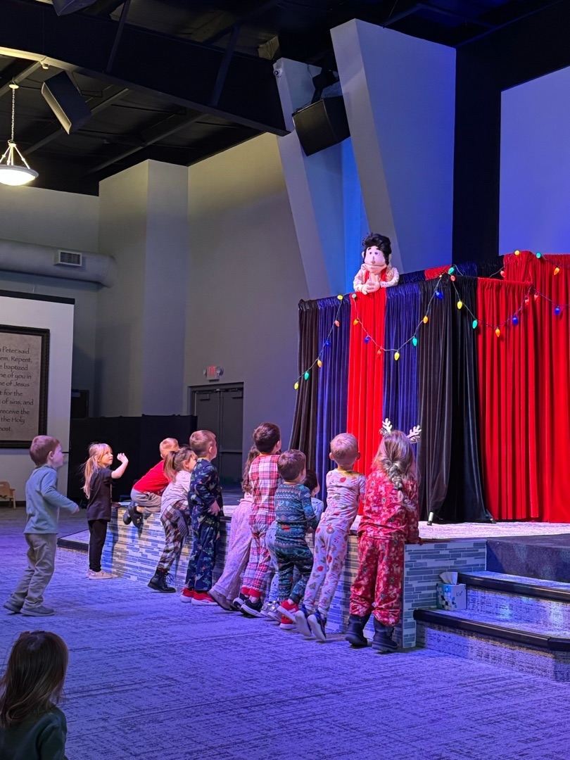 Children enjoying a holiday puppet show