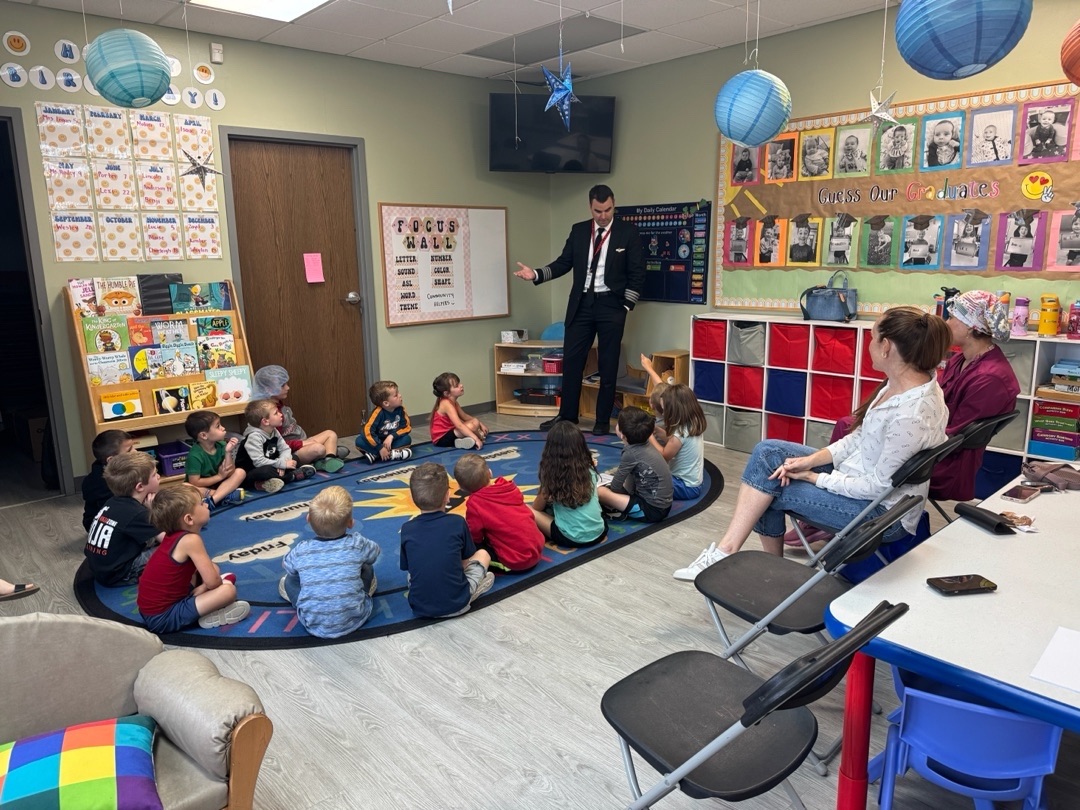 Community visitor speaking to children at River of Life Daycare